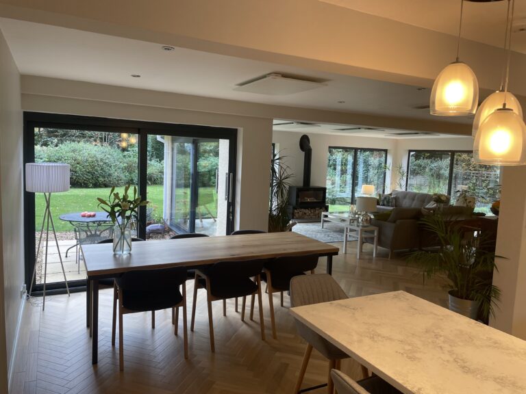 Open-plan kitchen and dining room with pendant lighting and glazed doors onto the garden