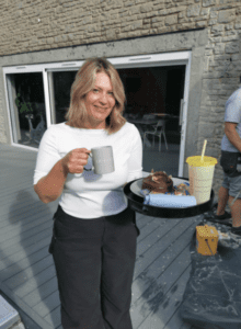 Member of the Excellence Living team with tea and a smoothie on site