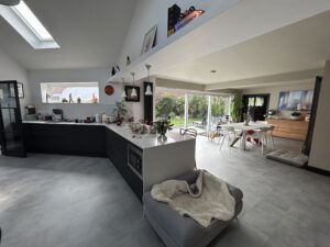 Open-plan kitchen under a vaulted ceiling with a rooflight