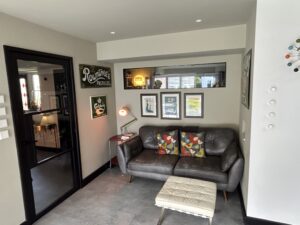 Snug with a leather sofa and a gallery wall of framed prints
