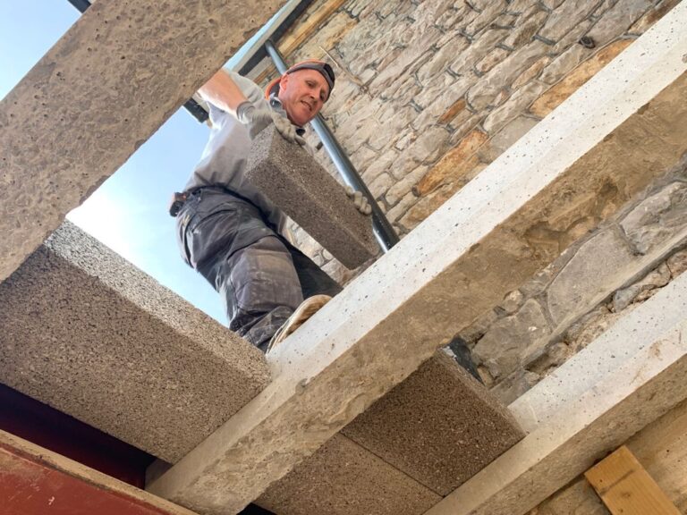 Team member fitting a floor structure over a lower-ground room