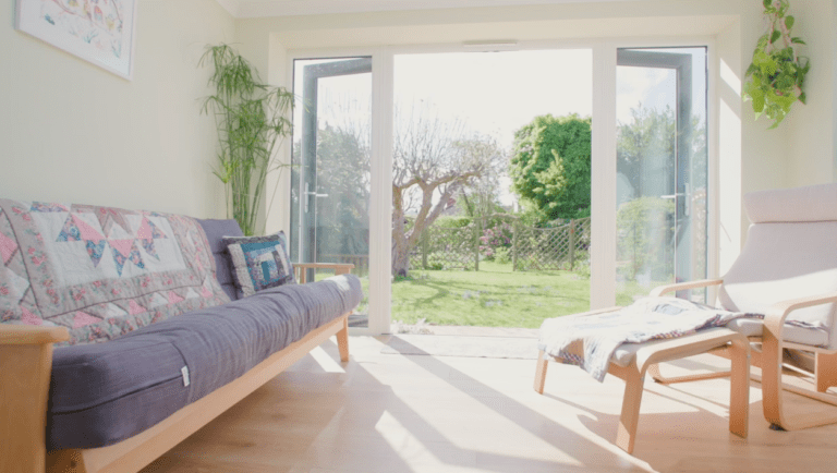 Sun room with garden doors, a futon and a wooden lounger