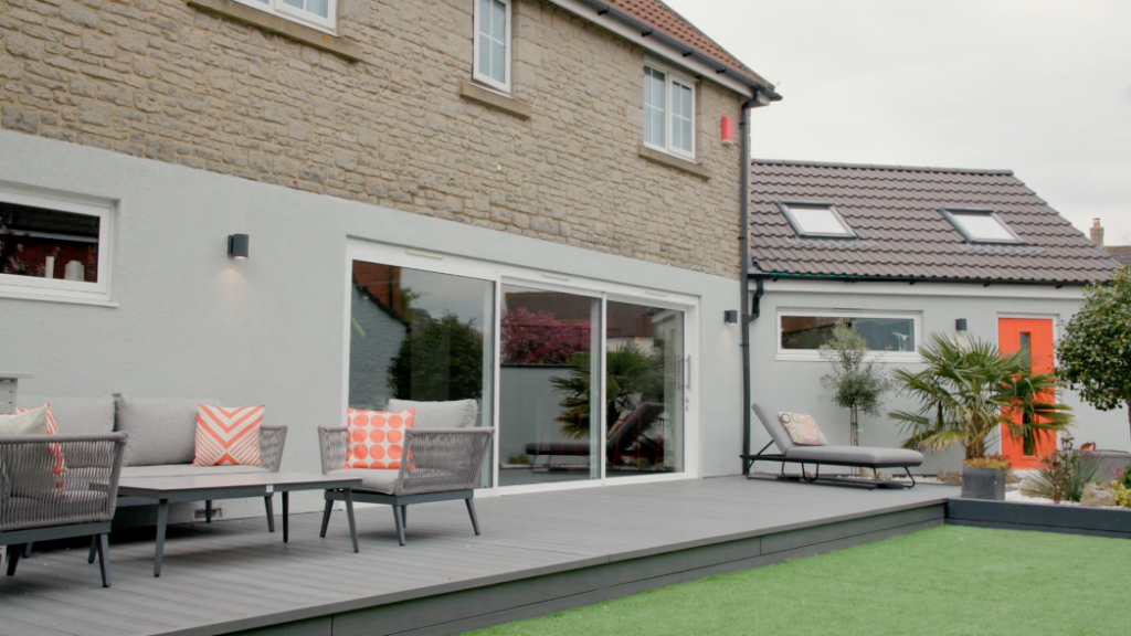 Rear of a house with a single-storey extension and paved terrace