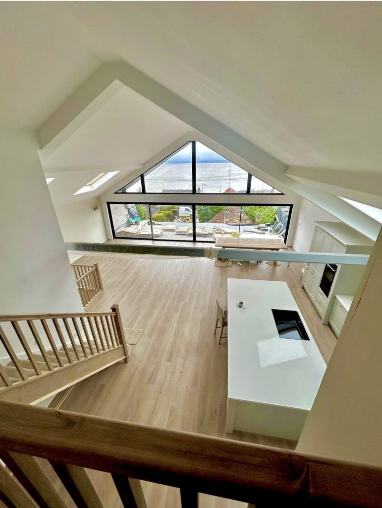 Vaulted landing with a glazed gable and oak balustrade