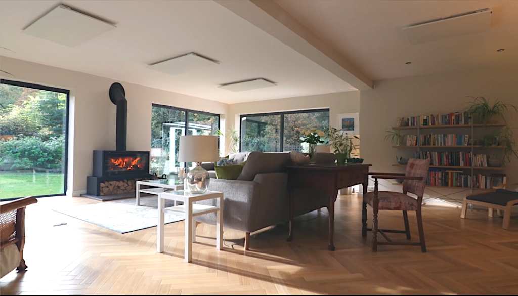 Living room in a rear extension with a wood burner and glazed doors onto the garden