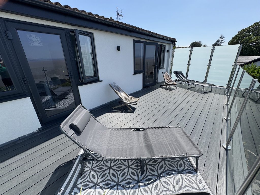 Roof terrace with a sun lounger and patterned outdoor rug