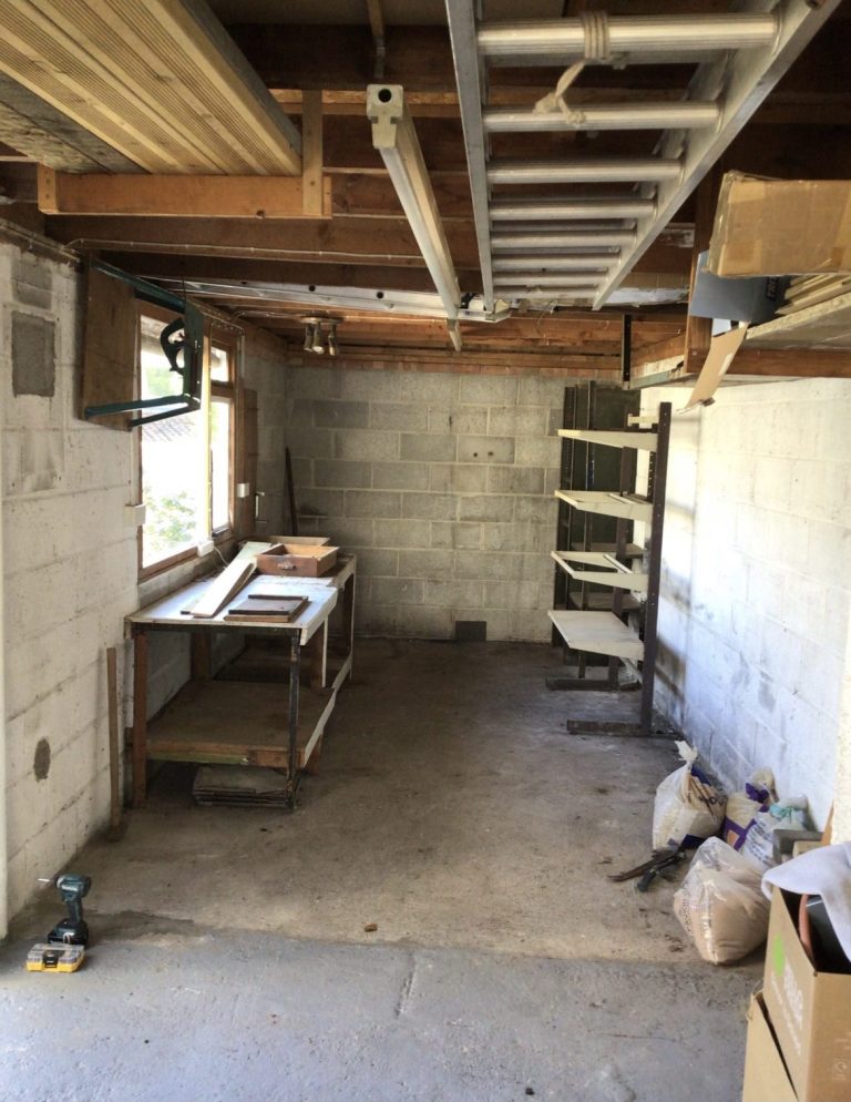 Lower-ground space during conversion, with blockwork walls and new floor structure