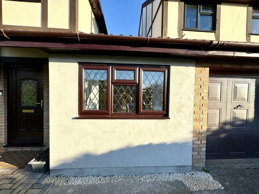 Front of a house where the garage has been converted, the door replaced with a window