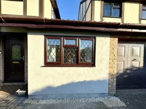 Front of a house where the garage has been converted, the door replaced with a window