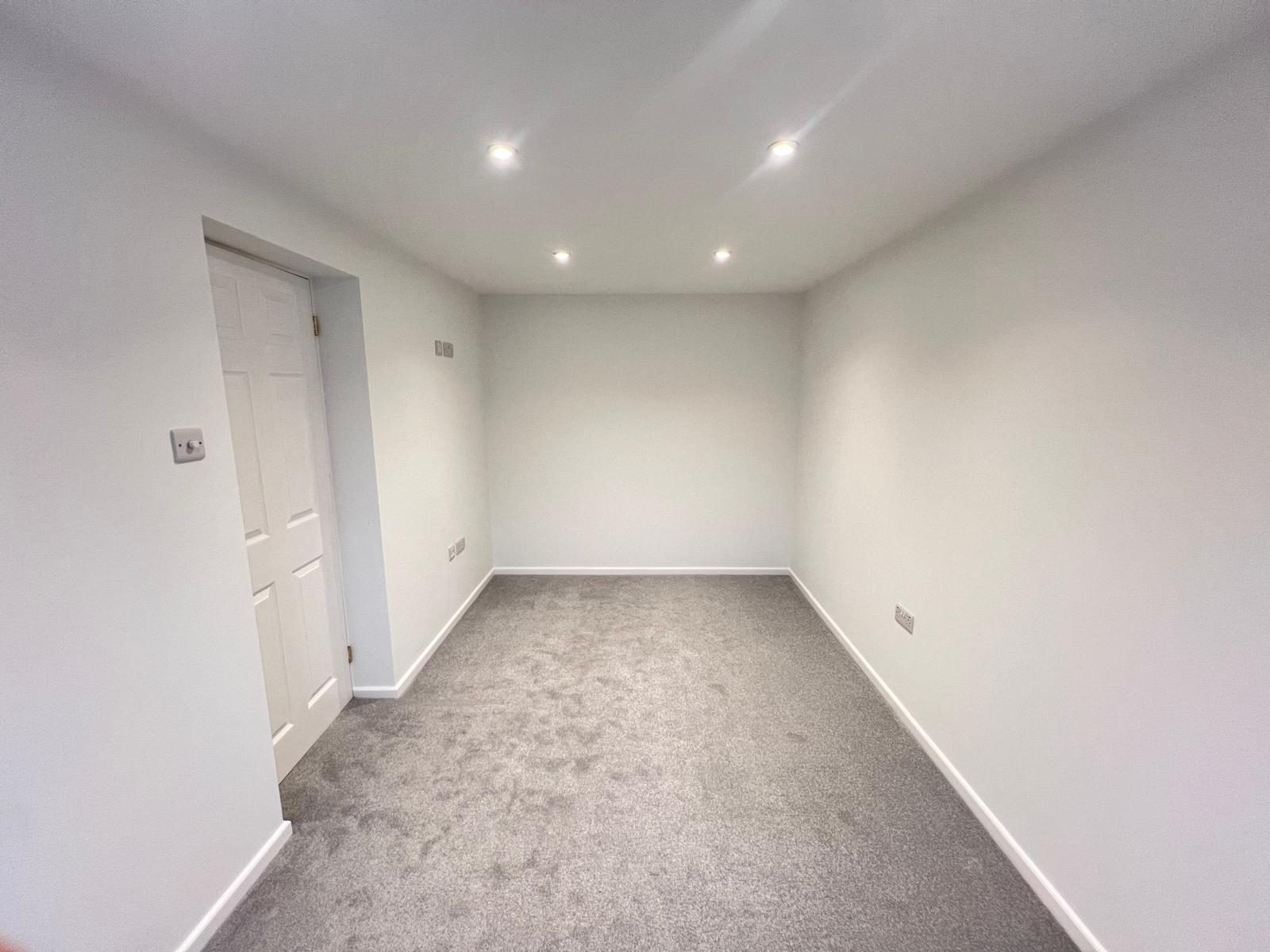 Finished lower-ground room, plastered and carpeted, ready for use