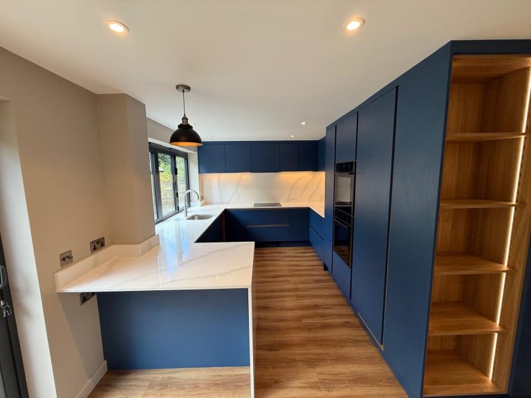 Navy blue kitchen with an oak-lined larder and integrated appliances