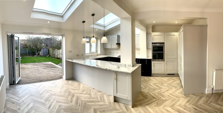 Kitchen with a rooflight, island and bifold doors onto the garden