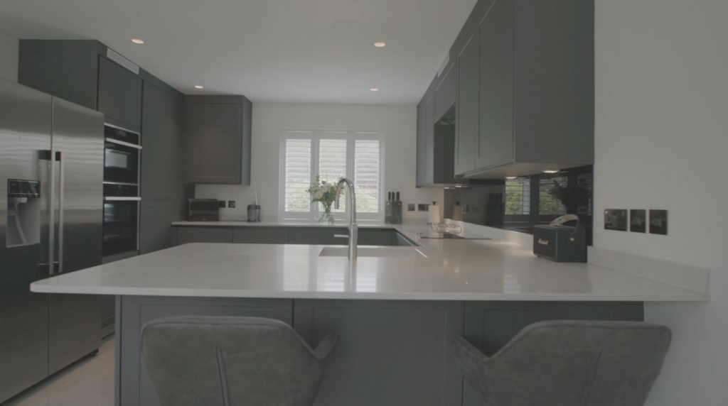 Grey kitchen with a large island and bar seating