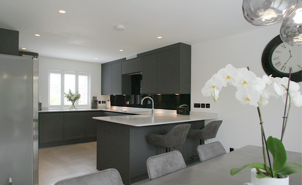 Kitchen with a dark island, orchid and window seating