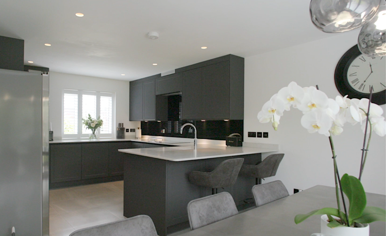 Kitchen with a dark island, orchid and window seating