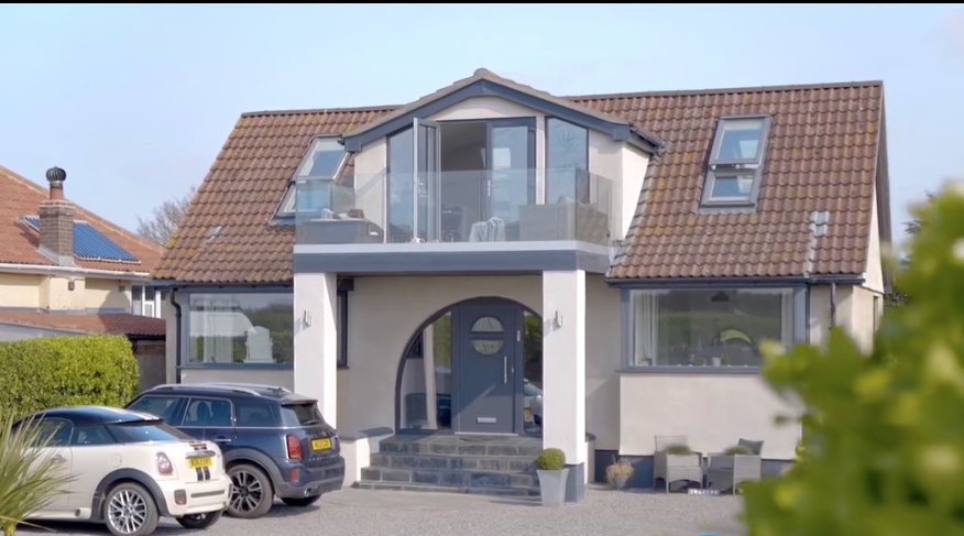 Front elevation of a house after a two-storey side extension and re-render